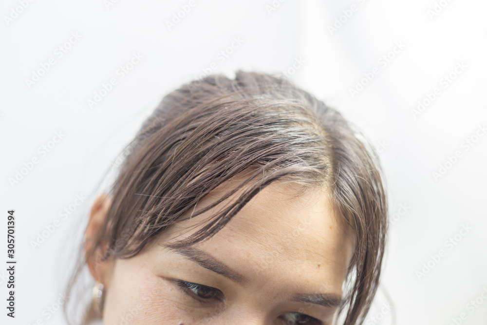 Charming brunette is not happy with fragile hair, on a white background. Charming brunette is not happy with fragile hair, on a white background.