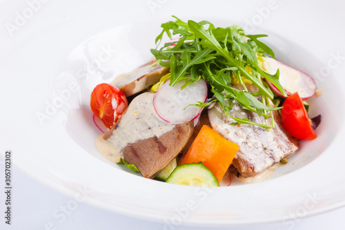 beef salad with greens and vegetables