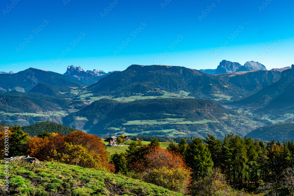 Overlooking the Schlern valley with the village of Kastelruth and the Dolomites mountains in the background