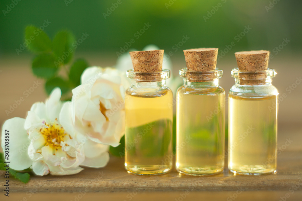 Essence of rose on table in beautiful glass bottle Essence of rose on table in beautiful glass bottle
