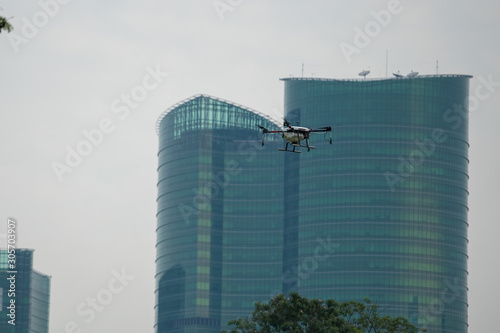 Industrial Drone Flying in town with building in background photo