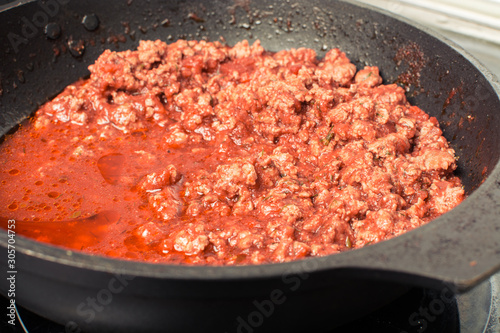 Cooked minced meat with bolognese tomato sauce for spaghetti.