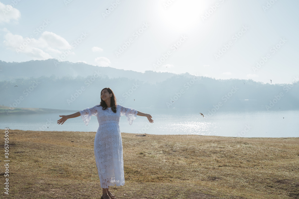 asian pregnant woman outstretched hand enjoy the morning air in nature asian pregnant woman outstretched hand enjoy the morning air in nature