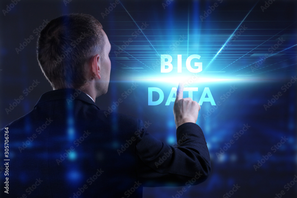 Business, Technology, Internet and network concept. Young businessman working on a virtual screen of the future and sees the inscription: Big data Business, Technology, Internet and network concept. Young businessman working on a virtual screen of the future and sees the inscription: Big data
