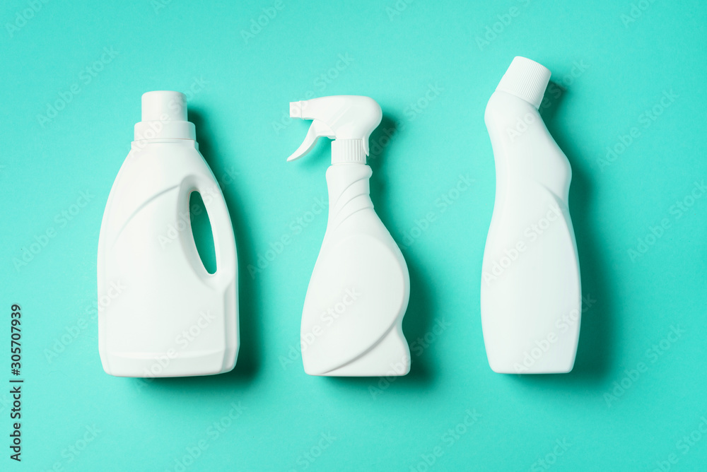 Composition with plastic bottles of cleaning products over blue background. Top view. Flat lay. Copy space. Plastic waste. Detergent bottle pattern Composition with plastic bottles of cleaning products over blue background. Top view. Flat lay. Copy space. Plastic waste. Detergent bottle pattern