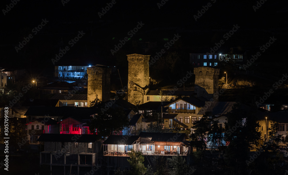 Night  panoramic view of the village of Mestia in Svaneti and the illuminated watchtowers - Koshki in the mountainous part of Georgia