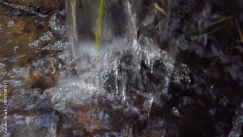 Waterfall water pouring down into river, close up