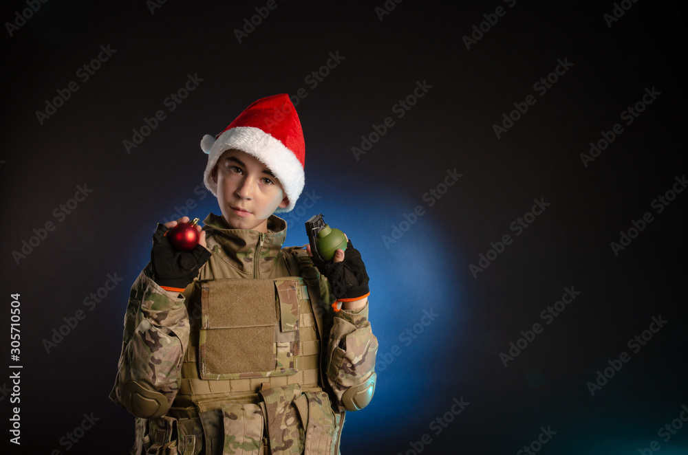 teen in soldier's uniform and Santa Claus hat teen in soldier's uniform and Santa Claus hat