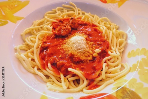 Spaghetti with tomato sauce and Parmesan cheese.