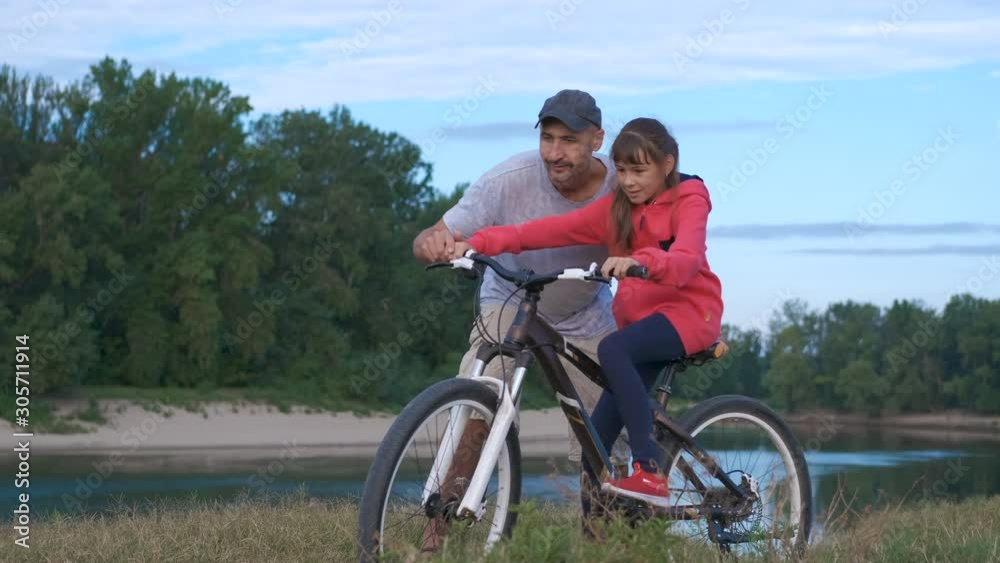 Dad with daughter on nature with a bicycle. Dad with daughter on nature with a bicycle.