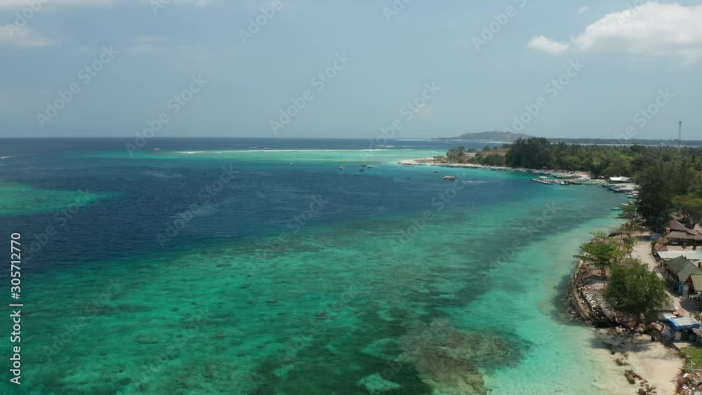 Ascending Aerial View of Exotic Island Coast With White Sand Beach and Coral Reefs. Bali, Gili Air, Indonesia Ascending Aerial View of Exotic Island Coast With White Sand Beach and Coral Reefs. Bali, Gili Air, Indonesia