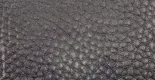 Сlose-up texture of black, genuine leath.