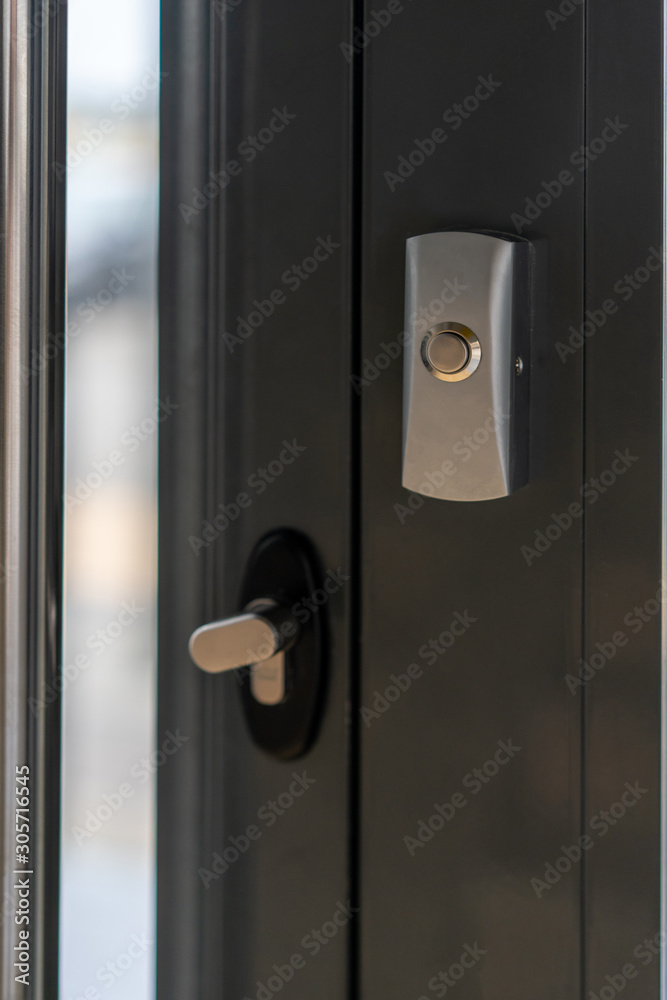 safety in residential buildings. metal door open button close up safety in residential buildings. metal door open button close up