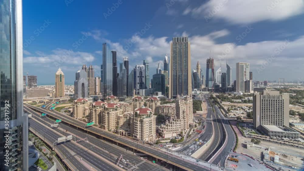 Skyline all day view of the buildings of Sheikh Zayed Road and DIFC timelapse with fast moving shadows in Dubai, UAE. Skyscrapers in financial centre aerial view from above in downtown Skyline all day view of the buildings of Sheikh Zayed Road and DIFC timelapse with fast moving shadows in Dubai, UAE. Skyscrapers in financial centre aerial view from above in downtown