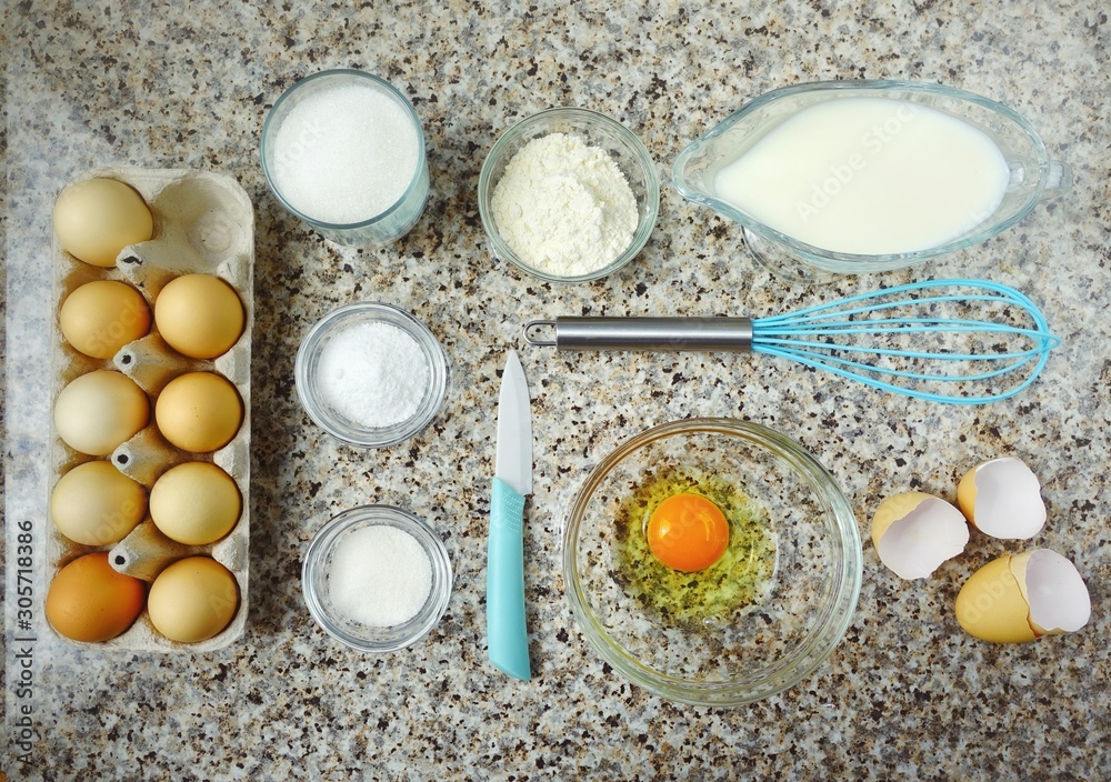 Eggs, milk and other products on the kitchen table.