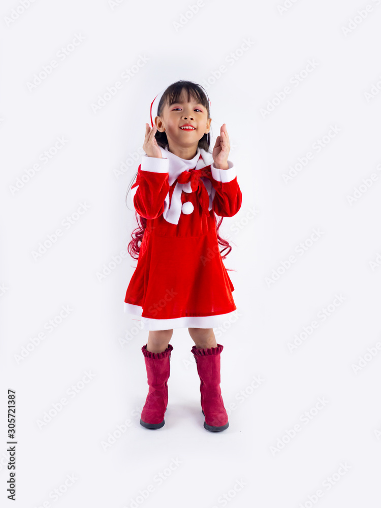Asian girl is wearing a Santa costume to celebrate Christmas. White background Asian girl is wearing a Santa costume to celebrate Christmas. White background