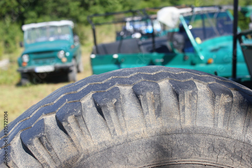 Retro style soviet off-road cars during a trip in forest
