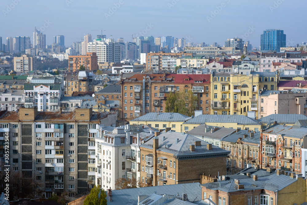 View of the city from a height. Panorama of the city in the fall, multi-storey buildings of different heights.