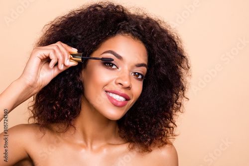 Close up photo beautiful amazing she her dark skin wavy model lady hold hands arms using new extra long lashes applicator advising buy buyer makeup studio nude isolated beige pastel background photo