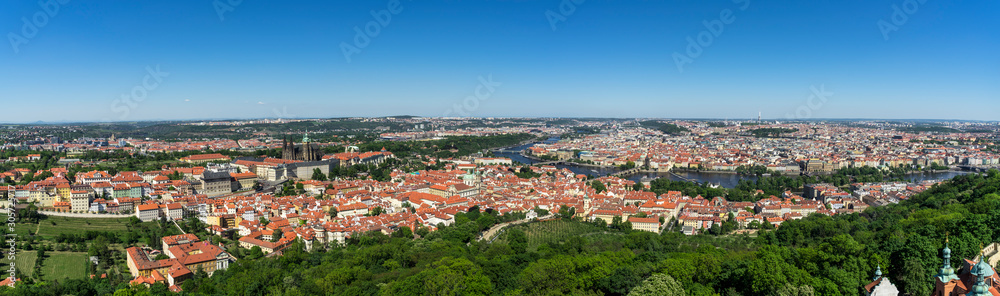Large panorama of the city of Prague in Czech Republic, from the Petrin hill. In foreground, the Mala Strana district with the castle. Then to the other side of the Vltava river, the old town.