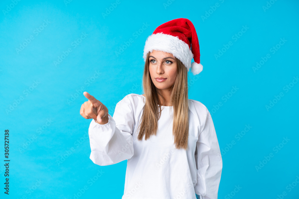Girl with christmas hat over isolated background touching on transparent screen Girl with christmas hat over isolated background touching on transparent screen