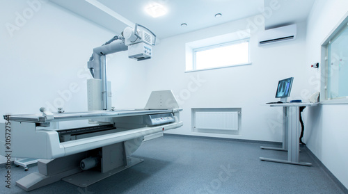 Clean and light X-ray room with chest on monitor