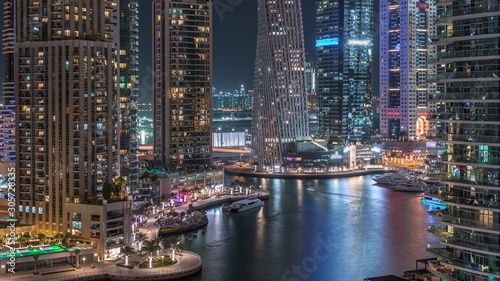 Aerial view of Dubai Marina residential and office skyscrapers with waterfront night timelapse © neiezhmakov