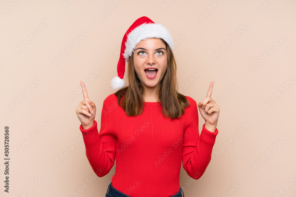 Young girl with christmas hat over isolated background pointing with the index finger a great idea Young girl with christmas hat over isolated background pointing with the index finger a great idea