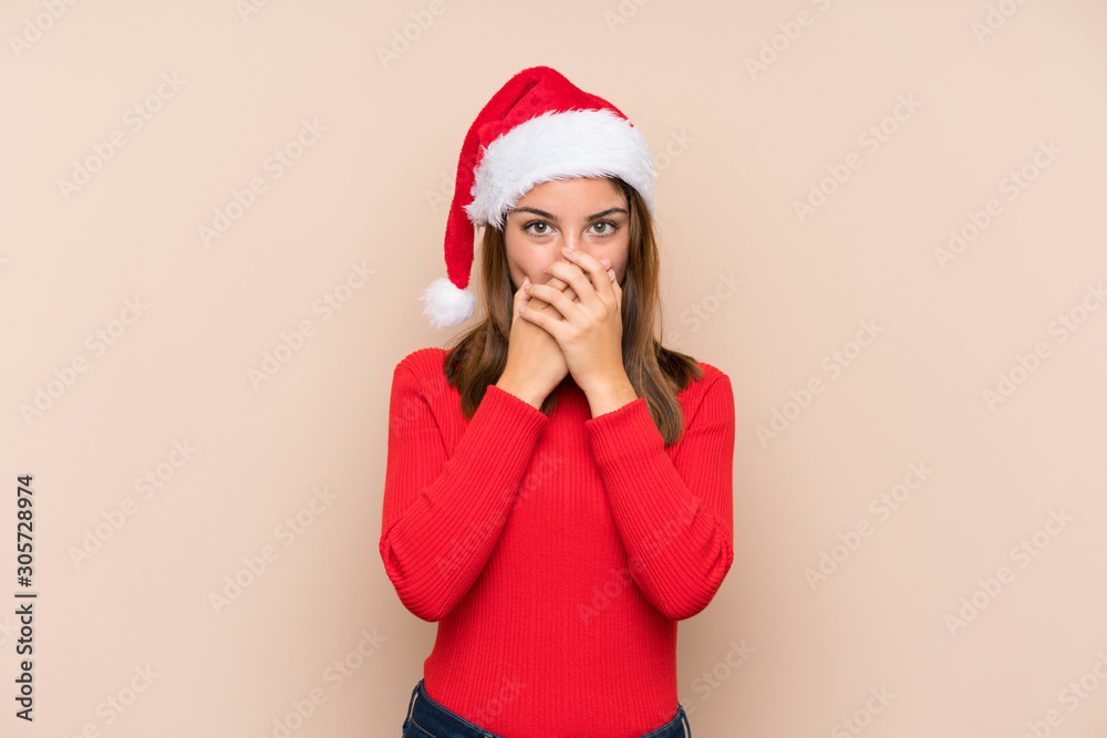 Young girl with christmas hat over isolated background with surprise facial expression Young girl with christmas hat over isolated background with surprise facial expression