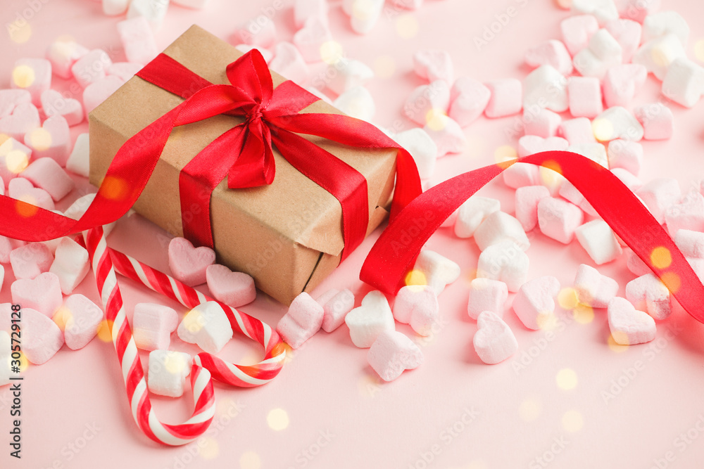 Gift box with red ribbon bow, copy space for your text, Happy Saint Valentine day background, sweet marshmallow on pink table, banner Gift box with red ribbon bow, copy space for your text, Happy Saint Valentine day background, sweet marshmallow on pink table, banner
