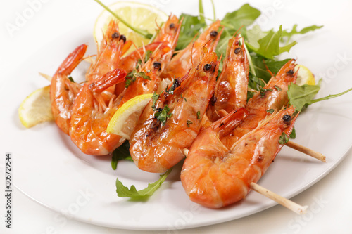 fried shrimp with lemon and salad in plate