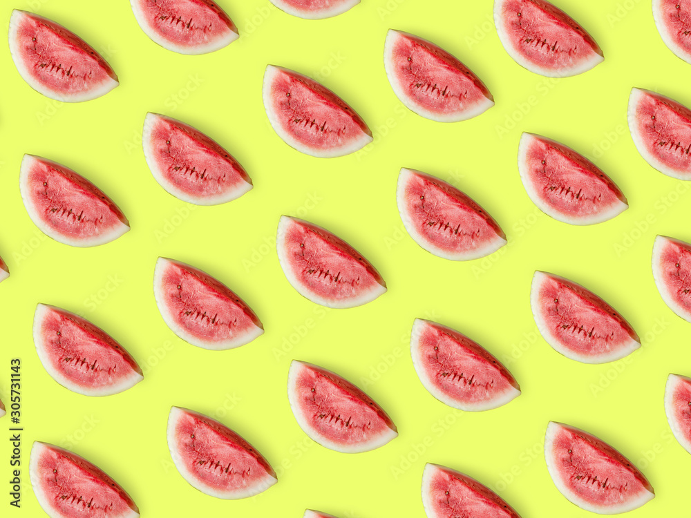 Pieces of ripe juicy watermelon on a light yellow background. Summer bright positive concept. Creative pattern, minimalism, top view, flat lay. Tasty and healthy food. C
