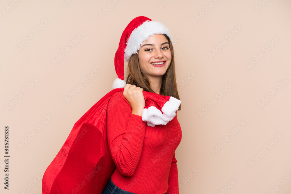 Young girl with christmas hat over isolated background Young girl with christmas hat over isolated background