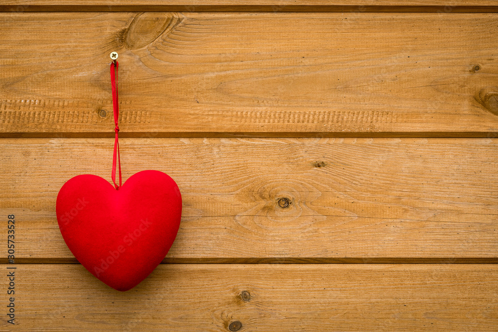 Red heart hanging on the wooden wall Red heart hanging on the wooden wall