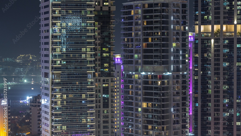 View of various skyscrapers and towers in Dubai Marina from above aerial night timelapse View of various skyscrapers and towers in Dubai Marina from above aerial night timelapse