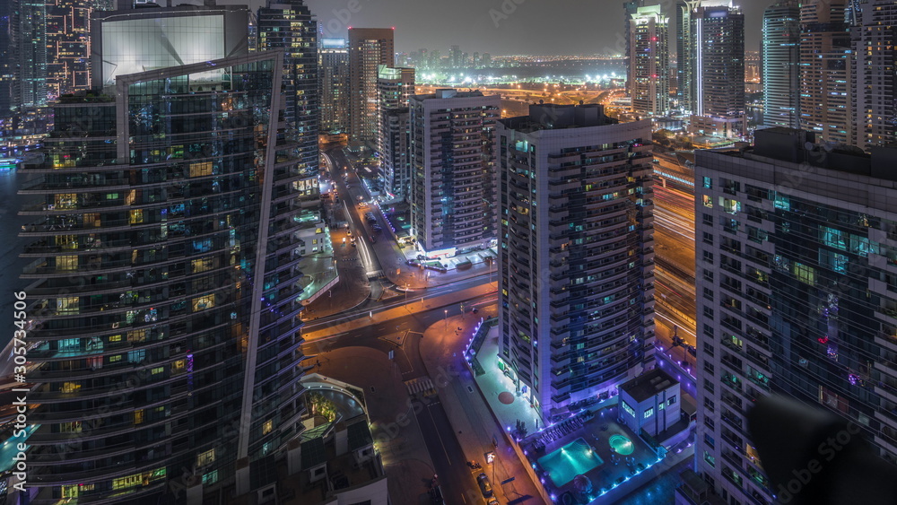 View of various skyscrapers and towers in Dubai Marina from above aerial night timelapse View of various skyscrapers and towers in Dubai Marina from above aerial night timelapse