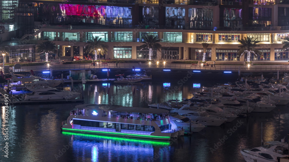 Waterfront promenade in Dubai Marina aerial night timelapse. Dubai, United Arab Emirates