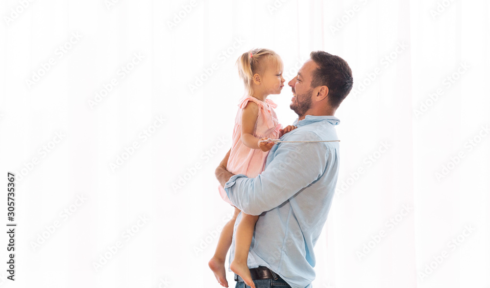 Daughter kissing her father sitting on his hands Daughter kissing her father sitting on his hands
