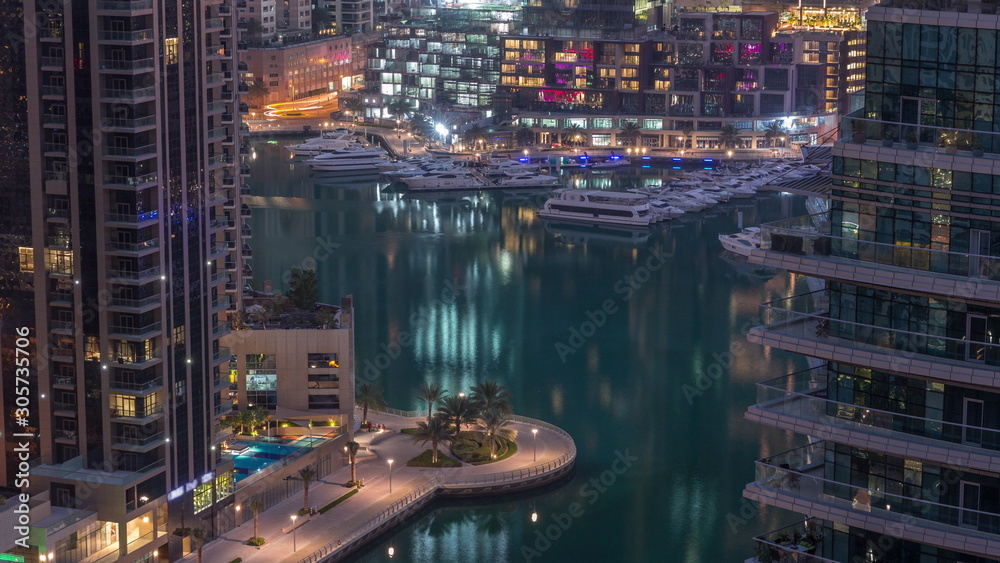 Waterfront promenade in Dubai Marina aerial night to day timelapse. Dubai, United Arab Emirates Waterfront promenade in Dubai Marina aerial night to day timelapse. Dubai, United Arab Emirates