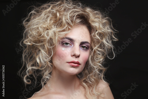 Vintage style portrait of young beautiful woman with fancy makeup and hairstyle