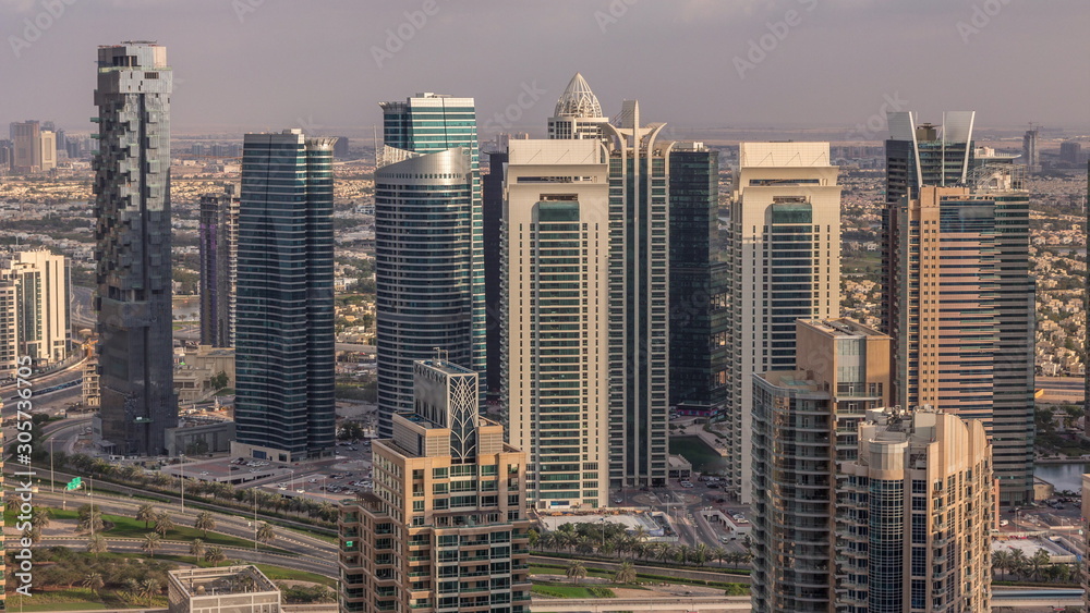 Obraz premium Dubai Marina skyscrapers and jumeirah lake towers view from the top aerial timelapse in the United Arab Emirates.