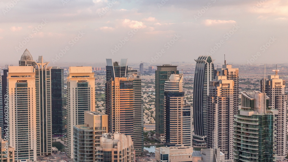 Obraz premium Dubai Marina skyscrapers and jumeirah lake towers view from the top aerial timelapse in the United Arab Emirates.