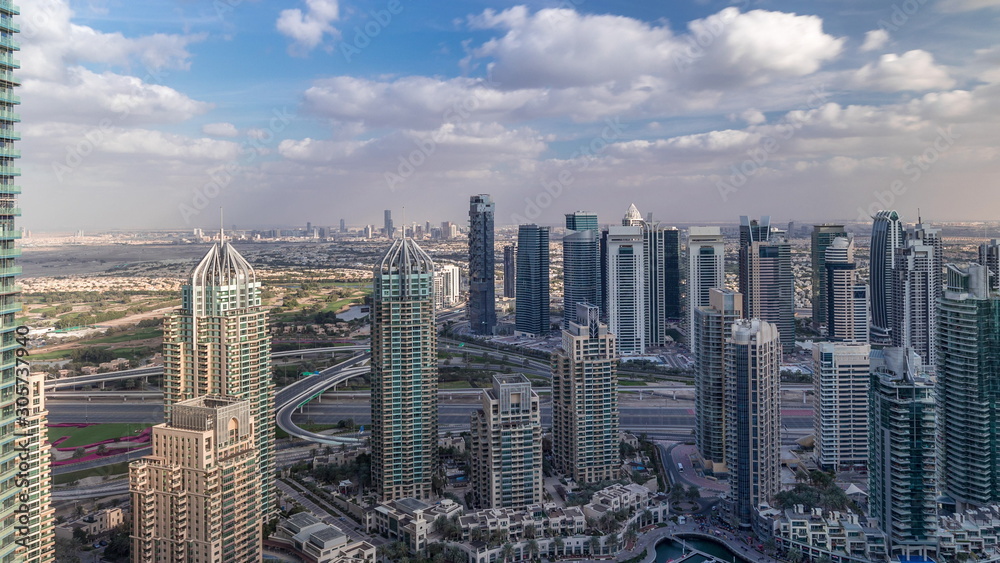 Fototapeta premium Dubai Marina skyscrapers and jumeirah lake towers view from the top aerial timelapse in the United Arab Emirates.