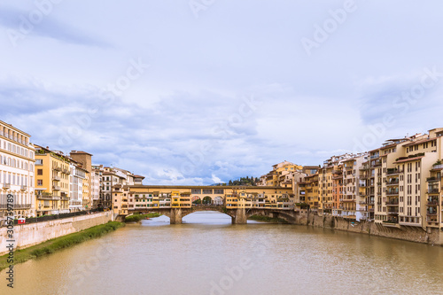 Cityscape with the famous Goldsmiths Bridge across the Arno river under the blue sky.. Firenze, Tuscany, Italy.