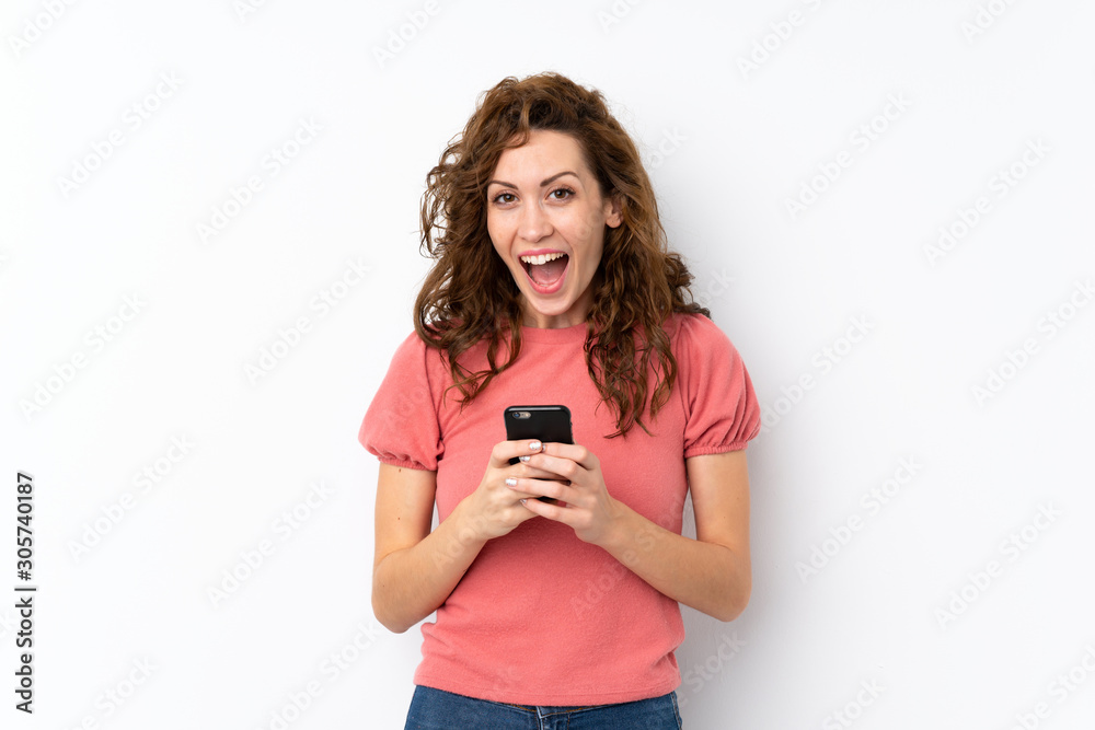 Young pretty woman over isolated background surprised and sending a message Young pretty woman over isolated background surprised and sending a message