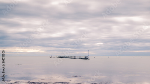 Jetty in the sea on a cloudy day in autumn