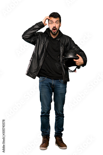 Full-length shot of Biker man with surprise expression over isolated white background