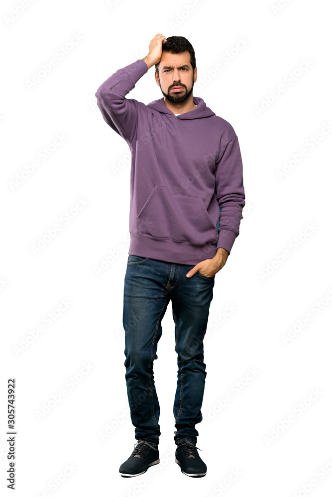 Full-length shot of Handsome man with sweatshirt with an expression of frustration and not understanding over isolated white background Full-length shot of Handsome man with sweatshirt with an expression of frustration and not understanding over isolated white background