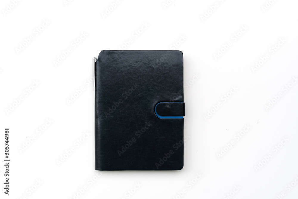 closed notebook with pen on white table, flat lay, top view, copy space closed notebook with pen on white table, flat lay, top view, copy space