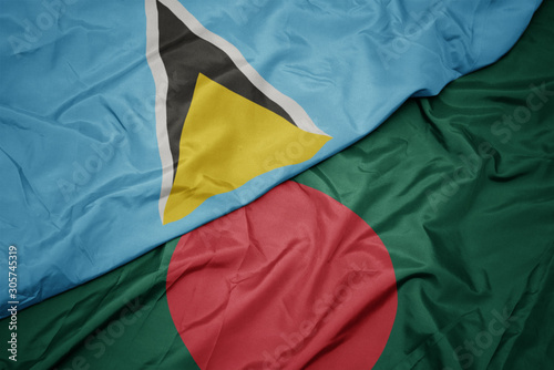 waving colorful flag of bangladesh and national flag of saint lucia.